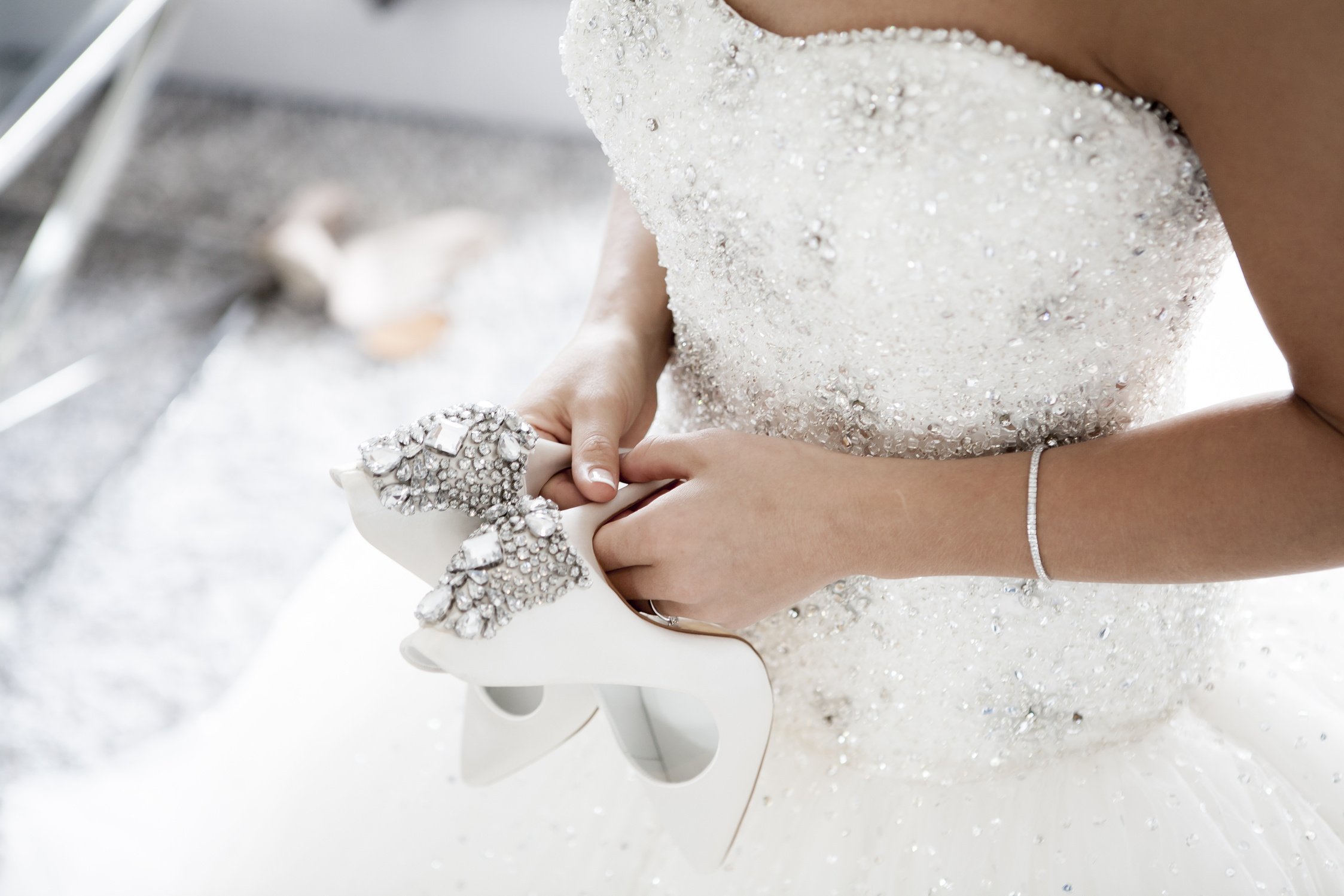 Bride Holding Her Bridal Shoes